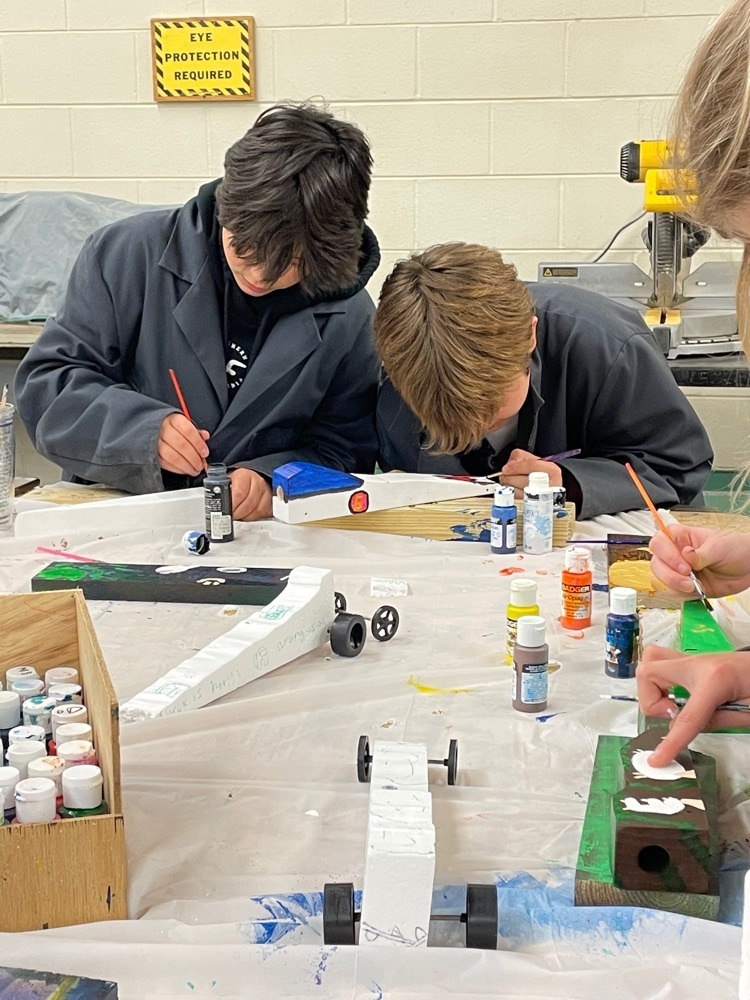 two students painting cars