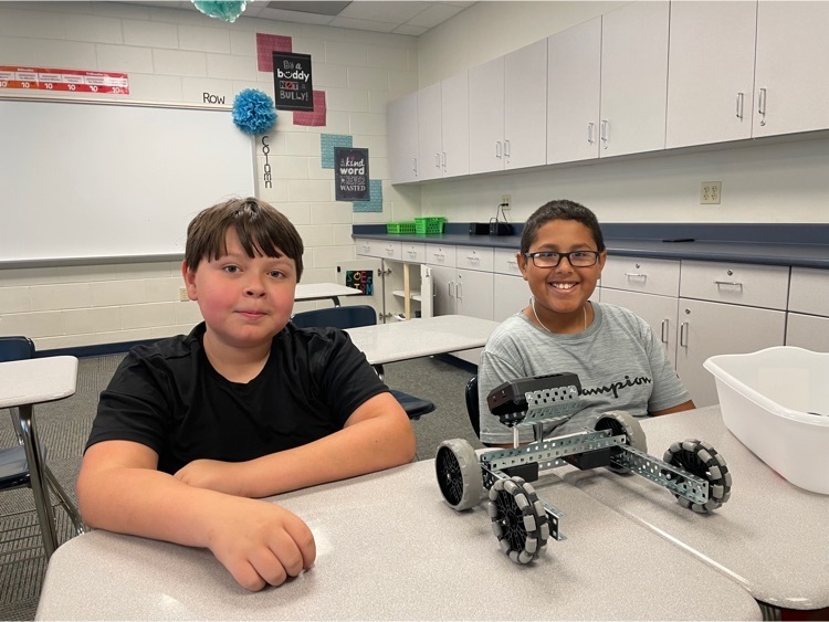 two boys with their robot