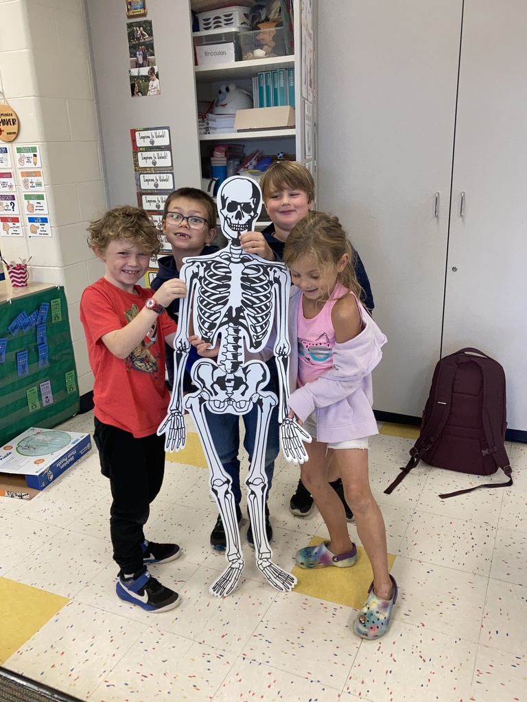 Student standing with a skeleton