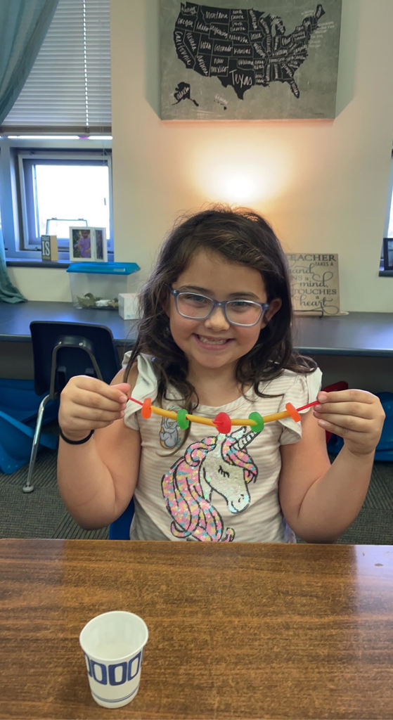 Student with model of a spinal cord