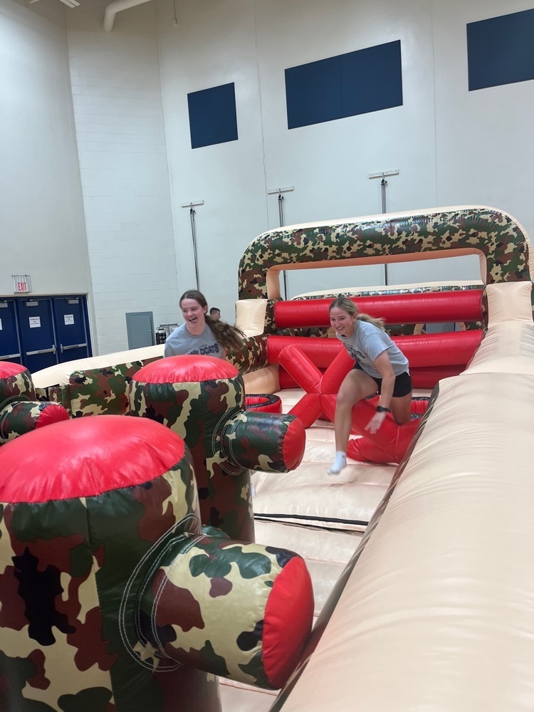 two students racing through inflatable course