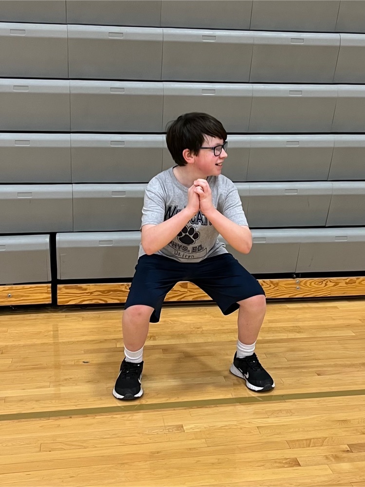 student doing squat